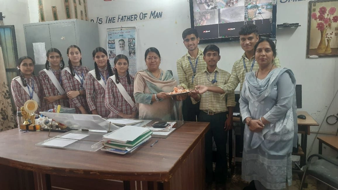 Teacher presenting award to group of students